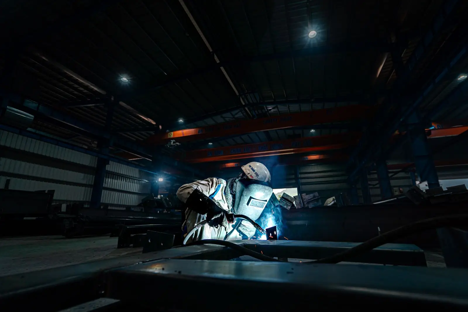 Technician working in a dim workshop bay